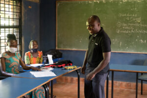 Musa teaching the students in the Personal Assistant Course at Kyambogo University.