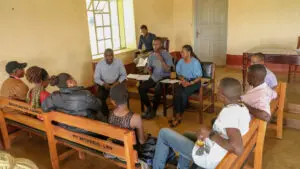 Youth with disabilities sit in a circle participating in a focus group discussion
